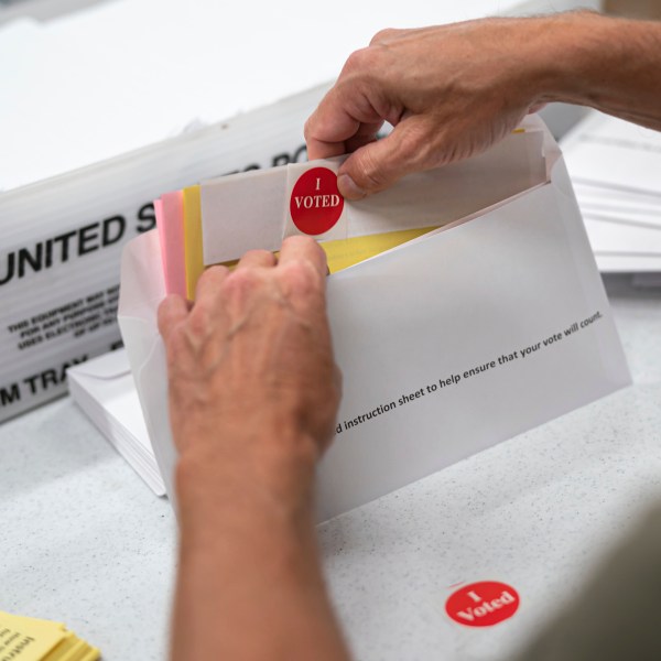 FILE - Mail in ballot envelopes including an I Voted sticker are prepared in Minneapolis, July 29, 2020. (Glen Stubbe/Star Tribune via AP, File)