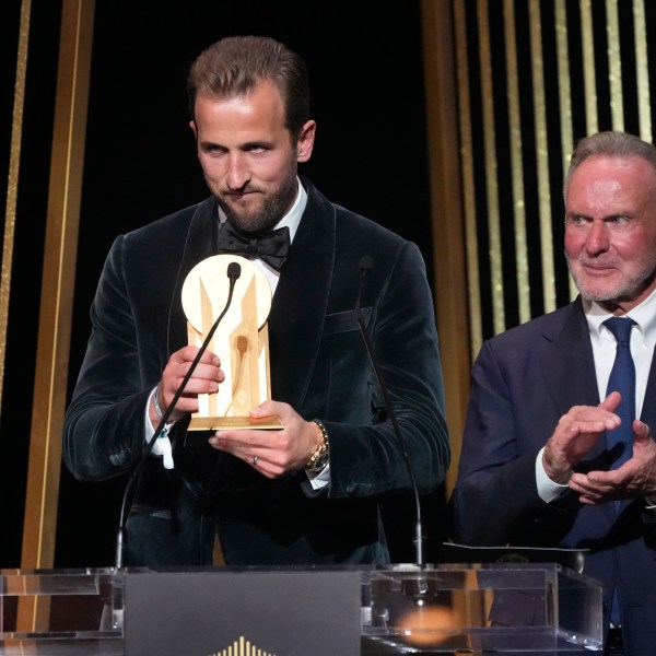 England's player Harry Kane, left, is flanked by former German player Karl-Heinz Rummenigge as he receives the Gerd Mueller trophy during the 68th Ballon d'Or (Golden Ball) award ceremony at Theatre du Chatelet in Paris, Monday, Oct. 28, 2024. (AP Photo/Michel Euler)