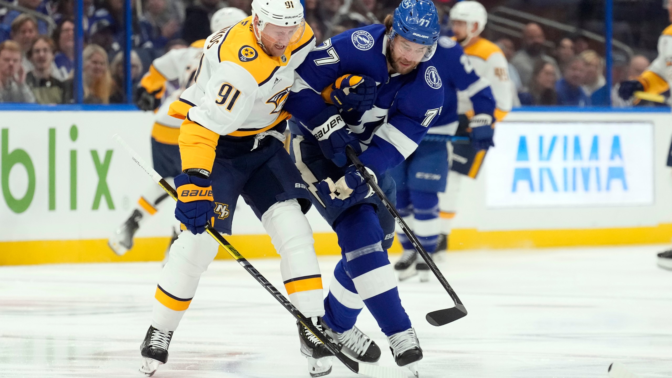 Nashville Predators center Steven Stamkos (91) and Tampa Bay Lightning defenseman Victor Hedman (77) battle for a loose puck during the first period of an NHL hockey game Monday, Oct. 28, 2024, in Tampa, Fla. (AP Photo/Chris O'Meara)