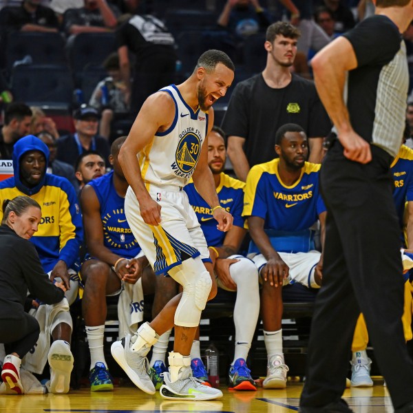 Golden State Warriors' Stephen Curry, center, yells after sustaining an injury to his left ankle in the fourth quarter of an NBA basketball game against the Los Angeles Clippers in San Francisco, Sunday, Oct. 27, 2024. (Jose Carlos Fajardo/Bay Area News Group via AP)