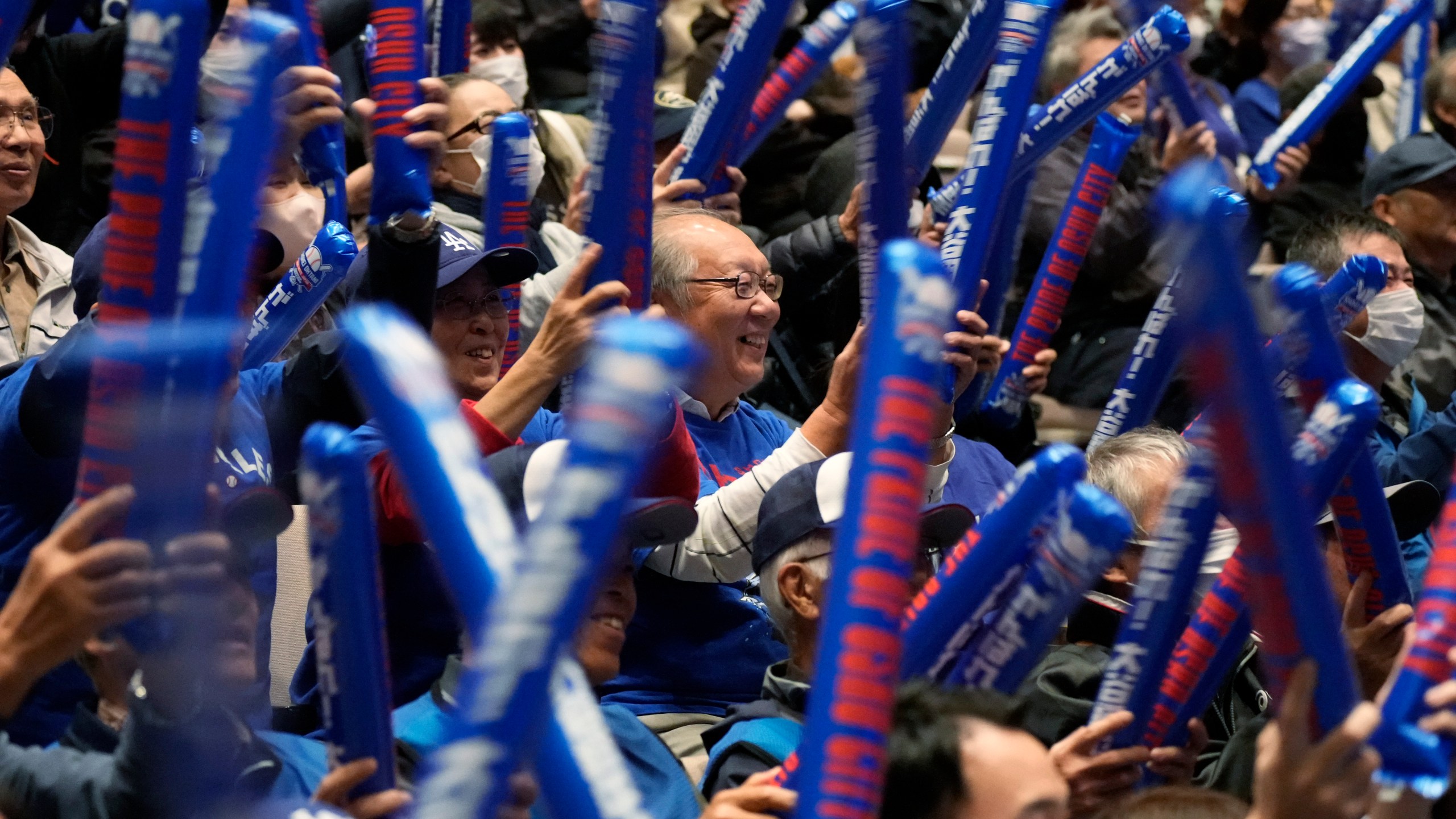 People watch a live stream before the start of Game 3 of the baseball World Series between the Los Angeles Dodgers and the New York Yankees during a public viewing event in Oshu, northeastern Japan, the hometown of Shohei Ohtani of the Dodgers, Tuesday, Oct. 29, 2024. (AP Photo/Eugene Hoshiko)