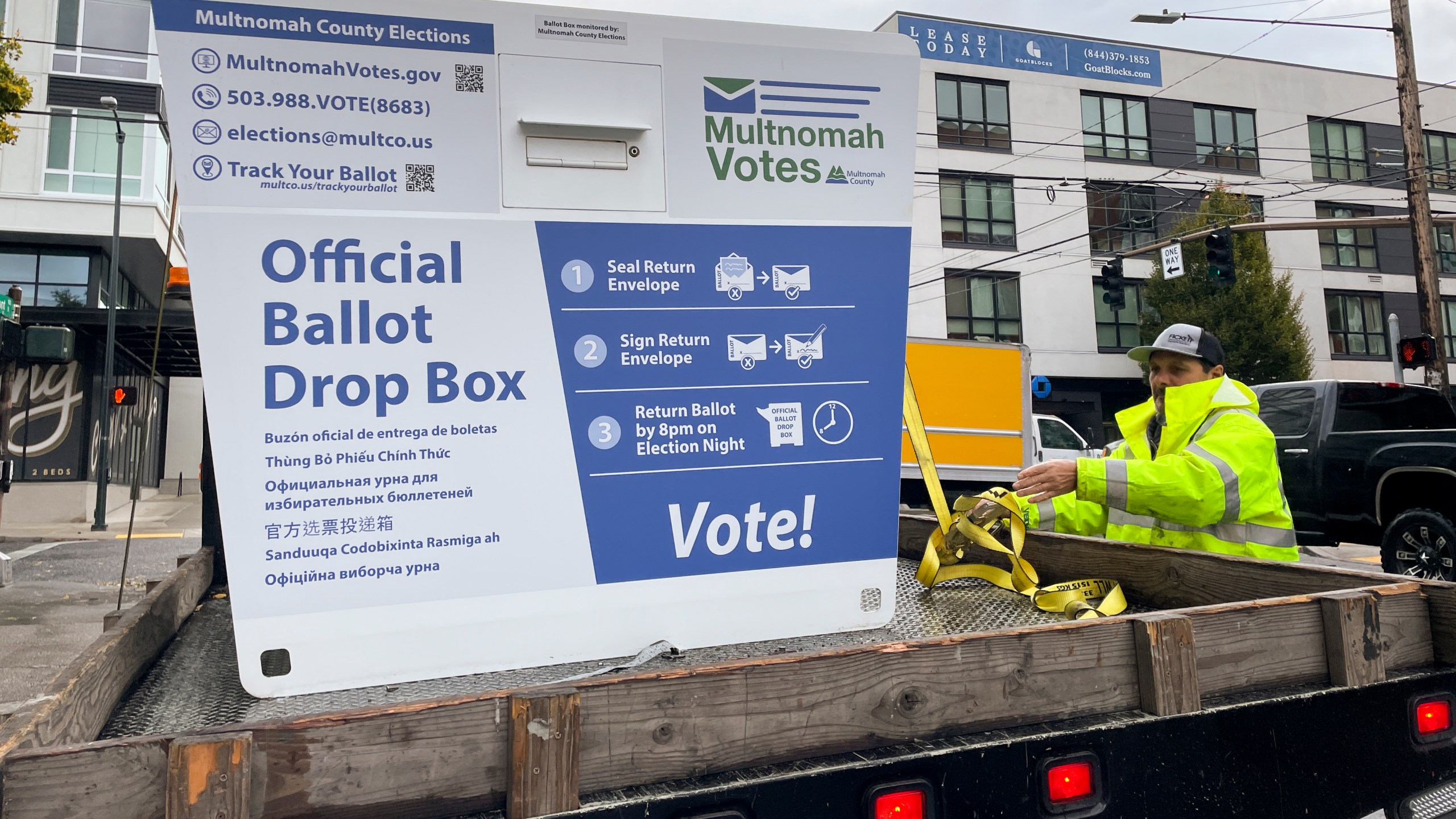 A replacement ballot drop box is unloaded on Monday, Oct. 28, 2024, in Portland, Ore. The Portland Police Bureau reported that officers and firefighters responded to a fire in one ballot drop box on Monday morning. (AP Photo/Claire Rush)