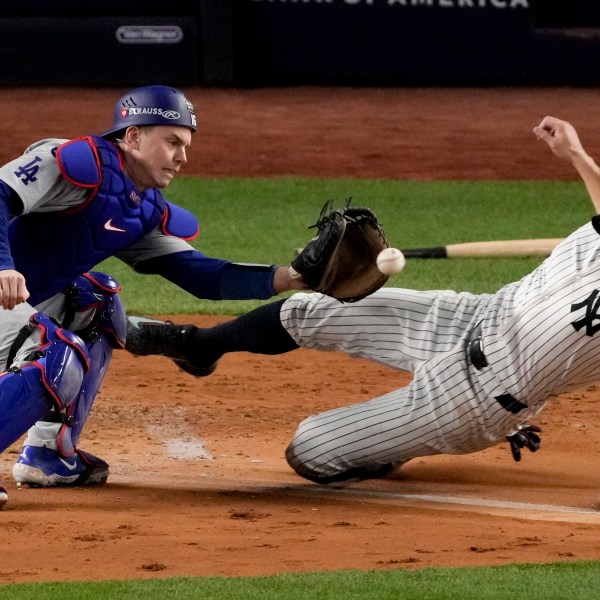 New York Yankees' Giancarlo Stanton is tagged out at home by Los Angeles Dodgers catcher Will Smith during the fourth inning in Game 3 of the baseball World Series, Monday, Oct. 28, 2024, in New York. (AP Photo/Frank Franklin II)