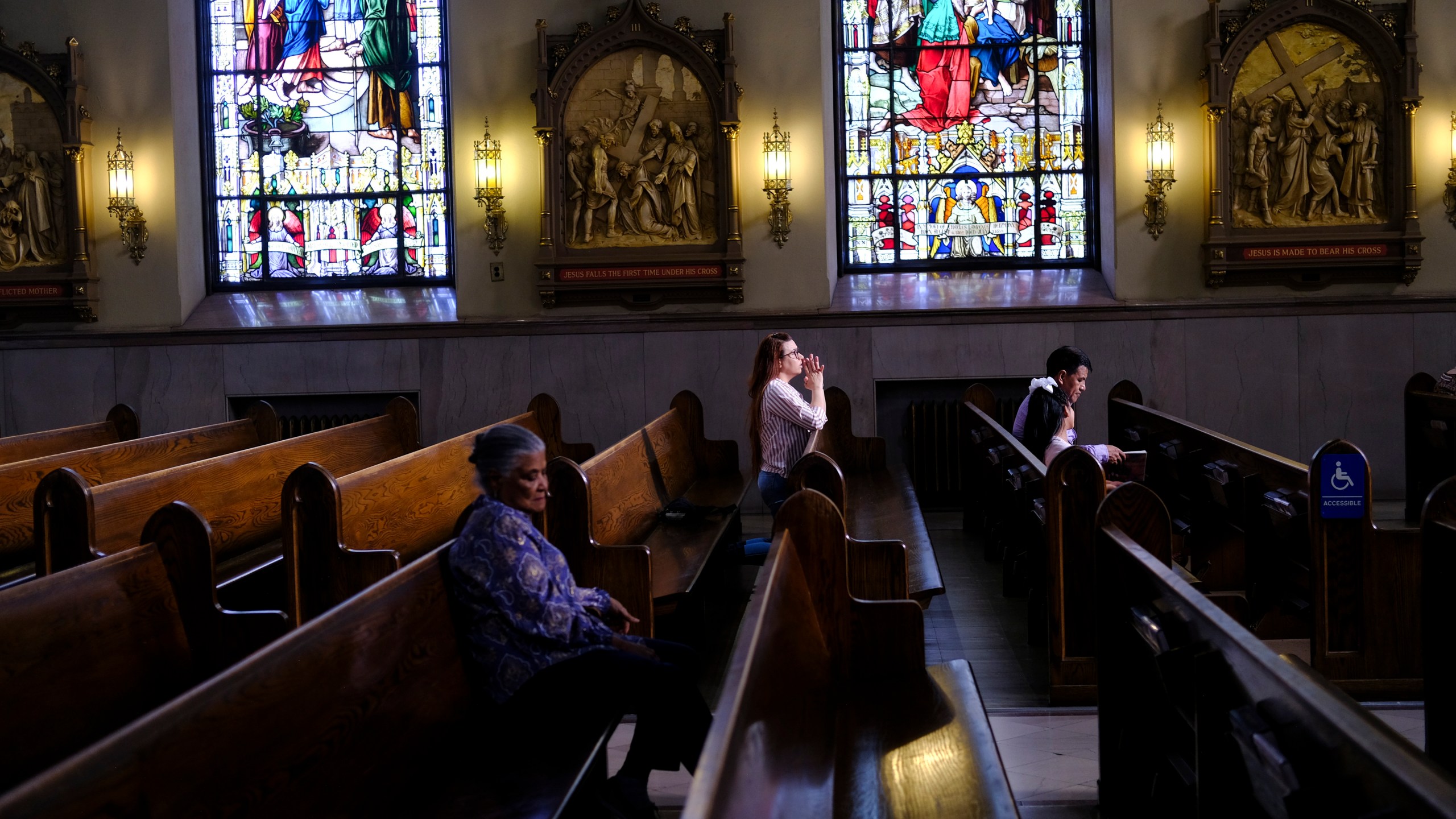 FILE - A parishioner prays at St. Peter the Apostle Catholic Church in Reading, Pa., on June 16, 2024. (AP Photo/Luis Andres Henao)