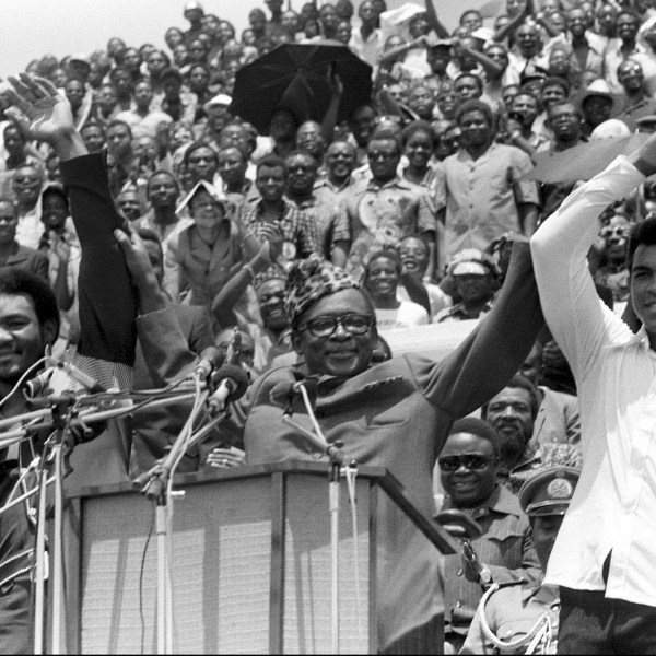 FILE - This is a Sept. 22, 1974 file photo of Zaire's President Mobutu Sese Seko, center, as he raises the arms of heavyweight champ George Foreman, left, and Muhammad Ali, right, in Kinshasa, Zaire. (AP Photo/Horst Faas, File)