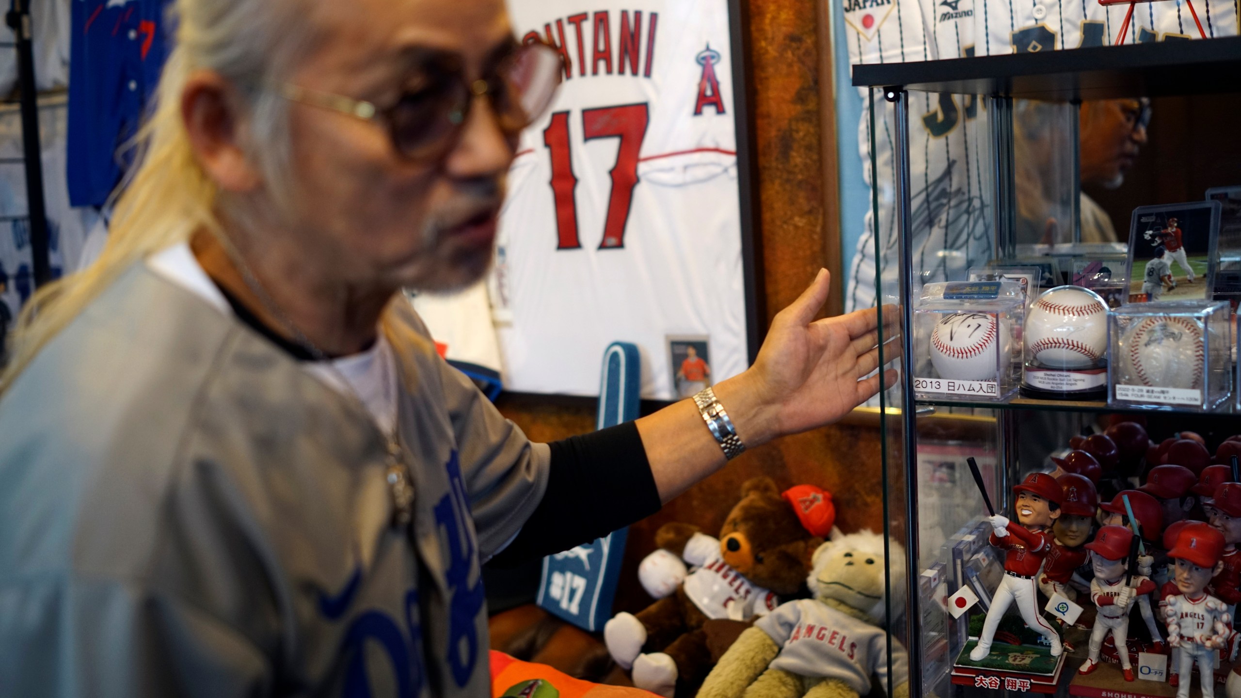 Hironobu Kanno, representative of a private fan club of Shohei Ohtani of the Los Angeles Dodgers, shows his collection items at his beauty salon in Oshu, northeastern Japan, the hometown of Ohtani, Tuesday, Oct. 29, 2024. (AP Photo/Eugene Hoshiko)