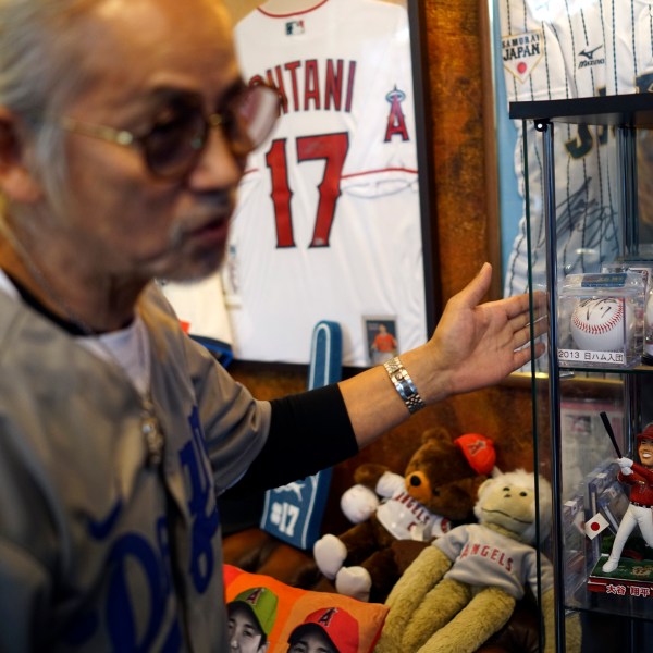 Hironobu Kanno, representative of a private fan club of Shohei Ohtani of the Los Angeles Dodgers, shows his collection items at his beauty salon in Oshu, northeastern Japan, the hometown of Ohtani, Tuesday, Oct. 29, 2024. (AP Photo/Eugene Hoshiko)