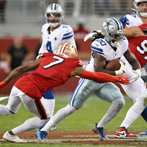 Dallas Cowboys running back Dalvin Cook (20) runs between San Francisco 49ers cornerback Charvarius Ward (7) and defensive end Nick Bosa (97) during the first half of an NFL football game in Santa Clara, Calif., Sunday, Oct. 27, 2024. (AP Photo/Eakin Howard)