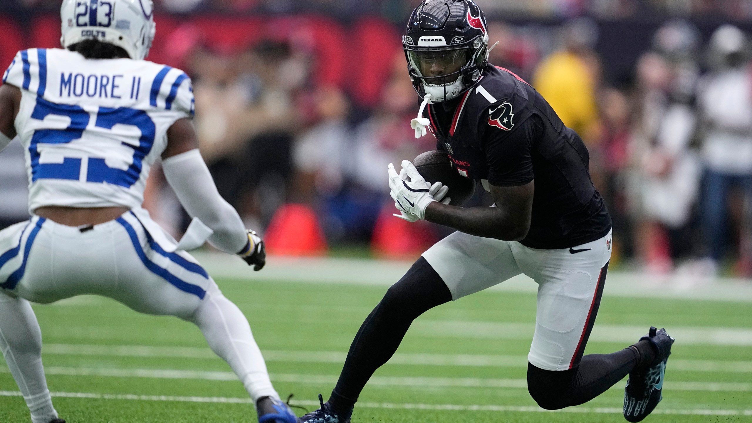 Houston Texans wide receiver Stefon Diggs (1) runs from Indianapolis Colts cornerback Kenny Moore II (23) after catching a pass during the first half of an NFL football game, Sunday, Oct. 27, 2024, in Houston. (AP Photo/Tony Gutierrez)