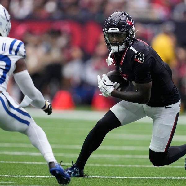 Houston Texans wide receiver Stefon Diggs (1) runs from Indianapolis Colts cornerback Kenny Moore II (23) after catching a pass during the first half of an NFL football game, Sunday, Oct. 27, 2024, in Houston. (AP Photo/Tony Gutierrez)