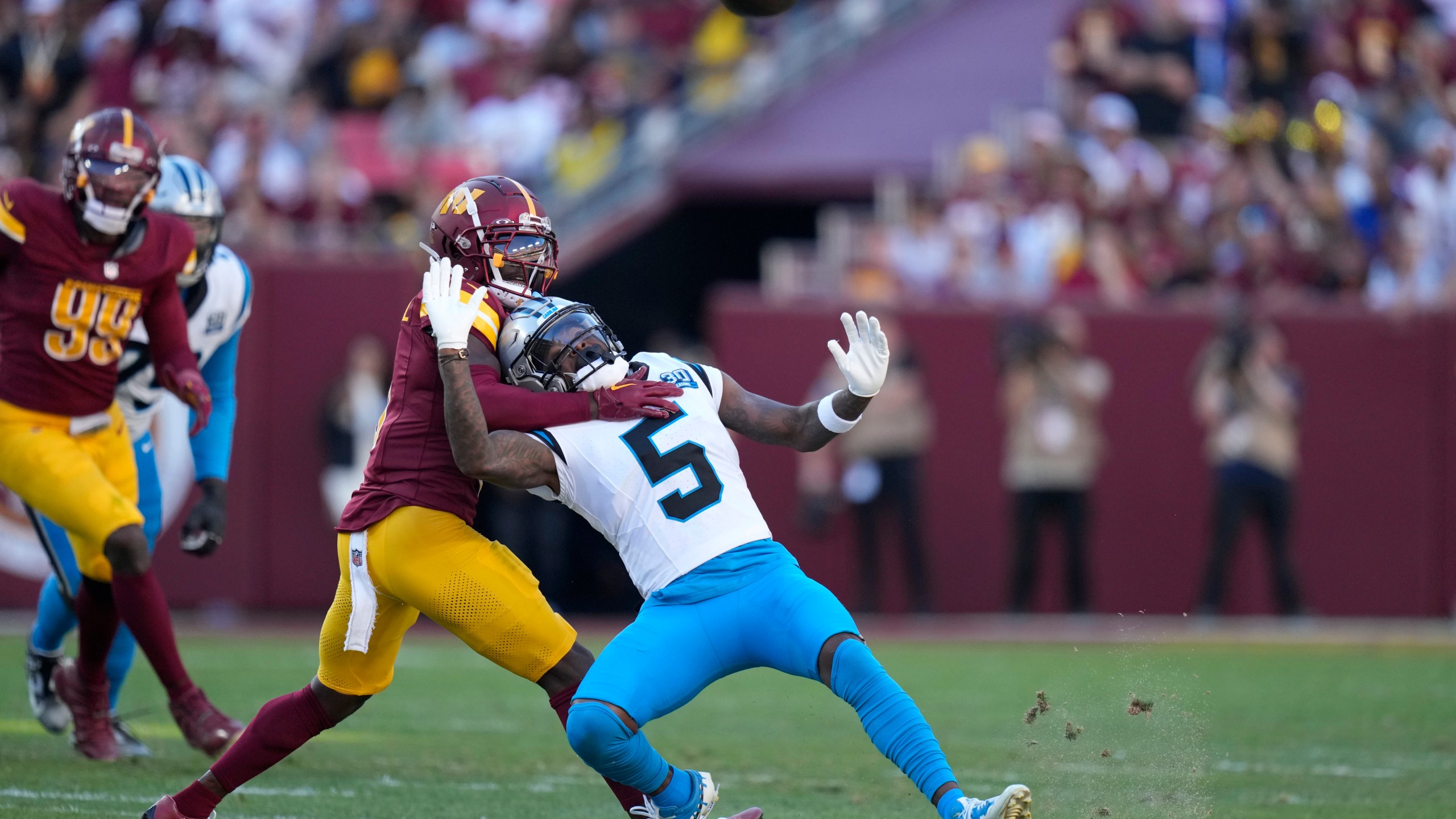 Washington Commanders linebacker Dante Fowler Jr. breaks up a pass intended for Carolina Panthers wide receiver Diontae Johnson (5) during the first half of an NFL football game, Sunday, Oct. 20, 2024, in Landover, Md. (AP Photo/Stephanie Scarbrough)