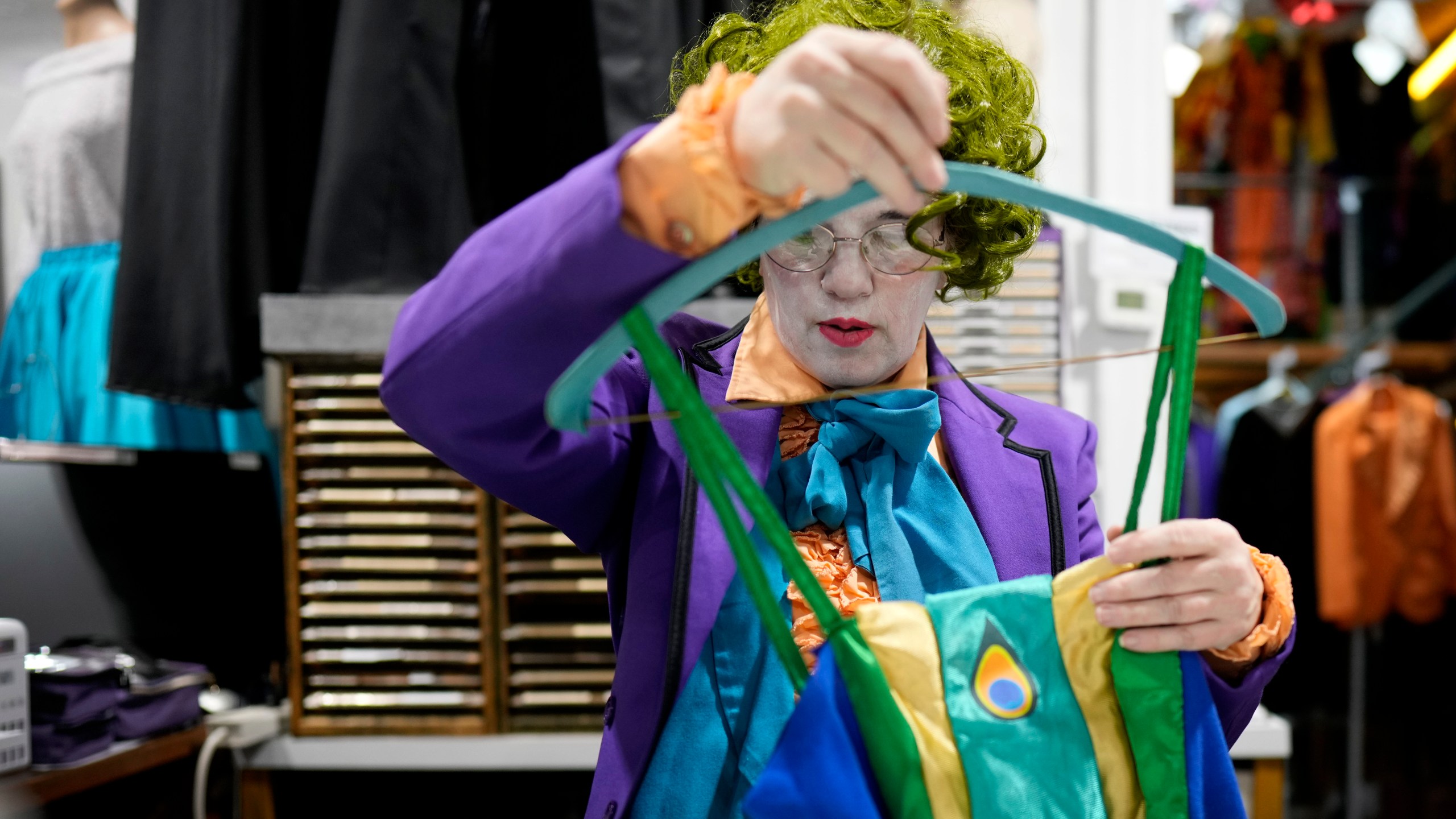 Michelle Nielsen prepares a costume for display at The Theatrical Shop, Tuesday, Oct. 29, 2024, in West Des Moines, Iowa. (AP Photo/Charlie Neibergall)