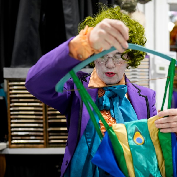 Michelle Nielsen prepares a costume for display at The Theatrical Shop, Tuesday, Oct. 29, 2024, in West Des Moines, Iowa. (AP Photo/Charlie Neibergall)