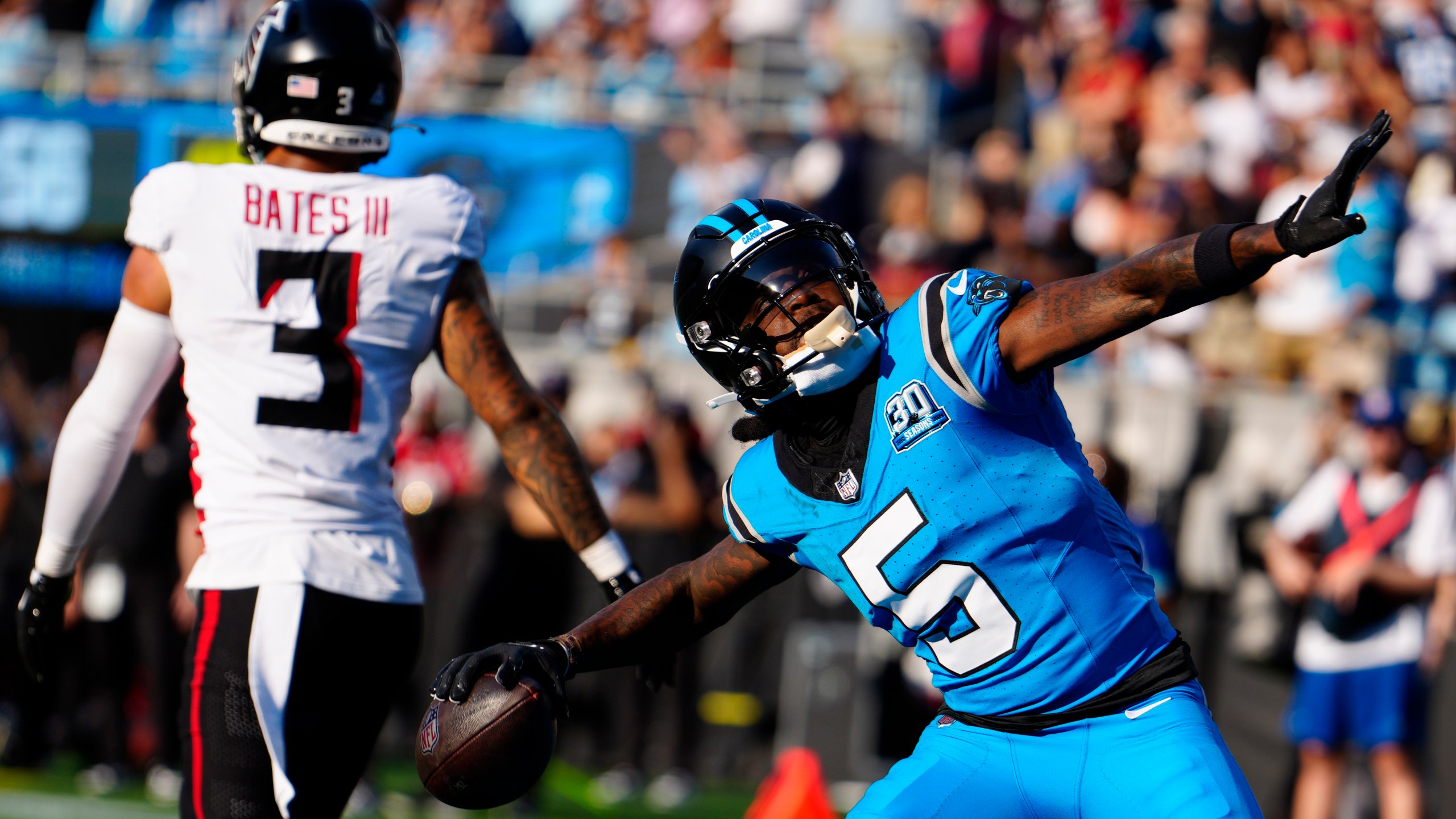 Carolina Panthers wide receiver Diontae Johnson (5) celebrates a touchdown in the first half of an NFL football game against the Atlanta Falcons in Charlotte, N.C., Sunday, Oct. 13, 2024. (AP Photo/Jacob Kupferman)