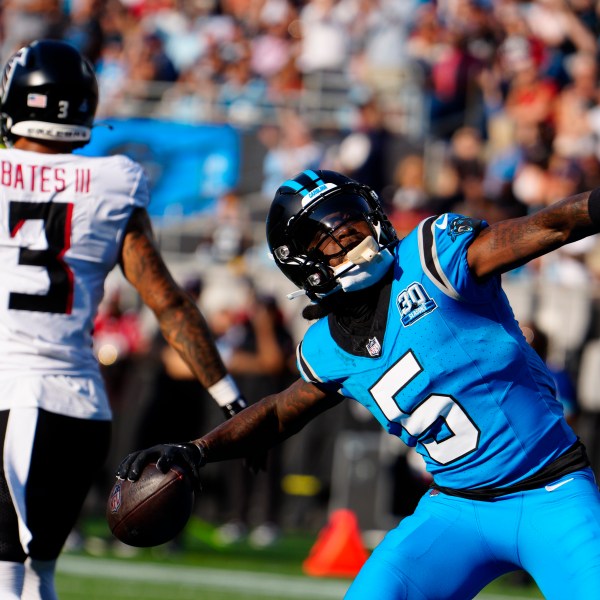 Carolina Panthers wide receiver Diontae Johnson (5) celebrates a touchdown in the first half of an NFL football game against the Atlanta Falcons in Charlotte, N.C., Sunday, Oct. 13, 2024. (AP Photo/Jacob Kupferman)