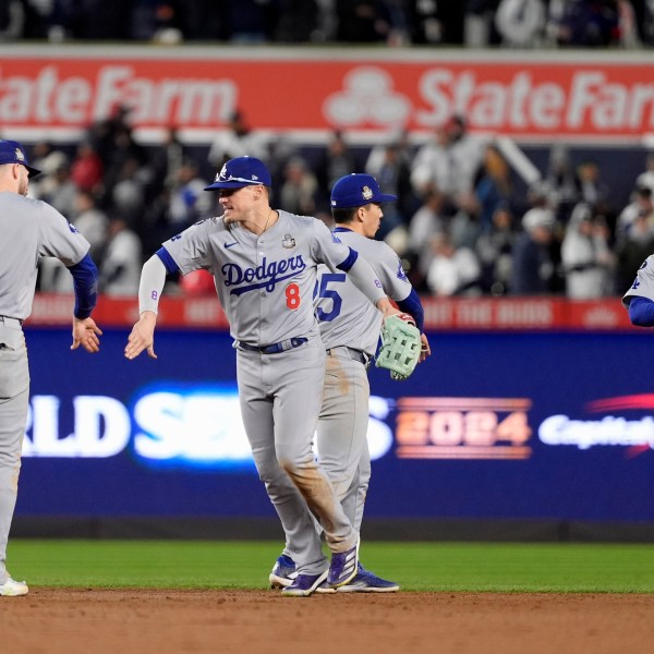 Los Angeles Dodgers' Gavin Lux (9), Kiké Hernández (8), Tommy Edman (25) and Mookie Betts (50) celebrate after Game 3 of the baseball World Series against the New York Yankees, Monday, Oct. 28, 2024, in New York. The Dodgers won 4-2. (AP Photo/Godofredo A. Vásquez)