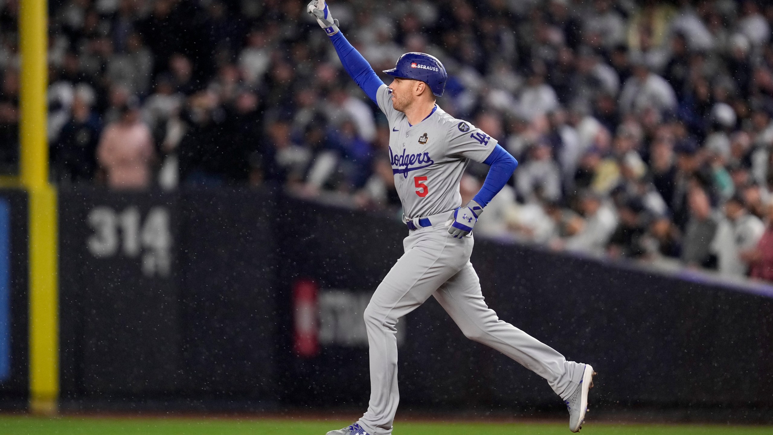 Los Angeles Dodgers' Freddie Freeman celebrates his two-run home run against the New York Yankees during the first inning in Game 4 of the baseball World Series, Tuesday, Oct. 29, 2024, in New York. (AP Photo/Ashley Landis)