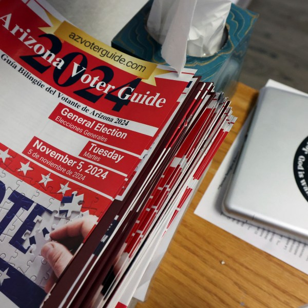 A 2024 Arizona Voter Guide is seen at Casa de Adoracion, Sunday, Oct. 27, 2024 in Phoenix. (AP Photo/Chris Coduto)