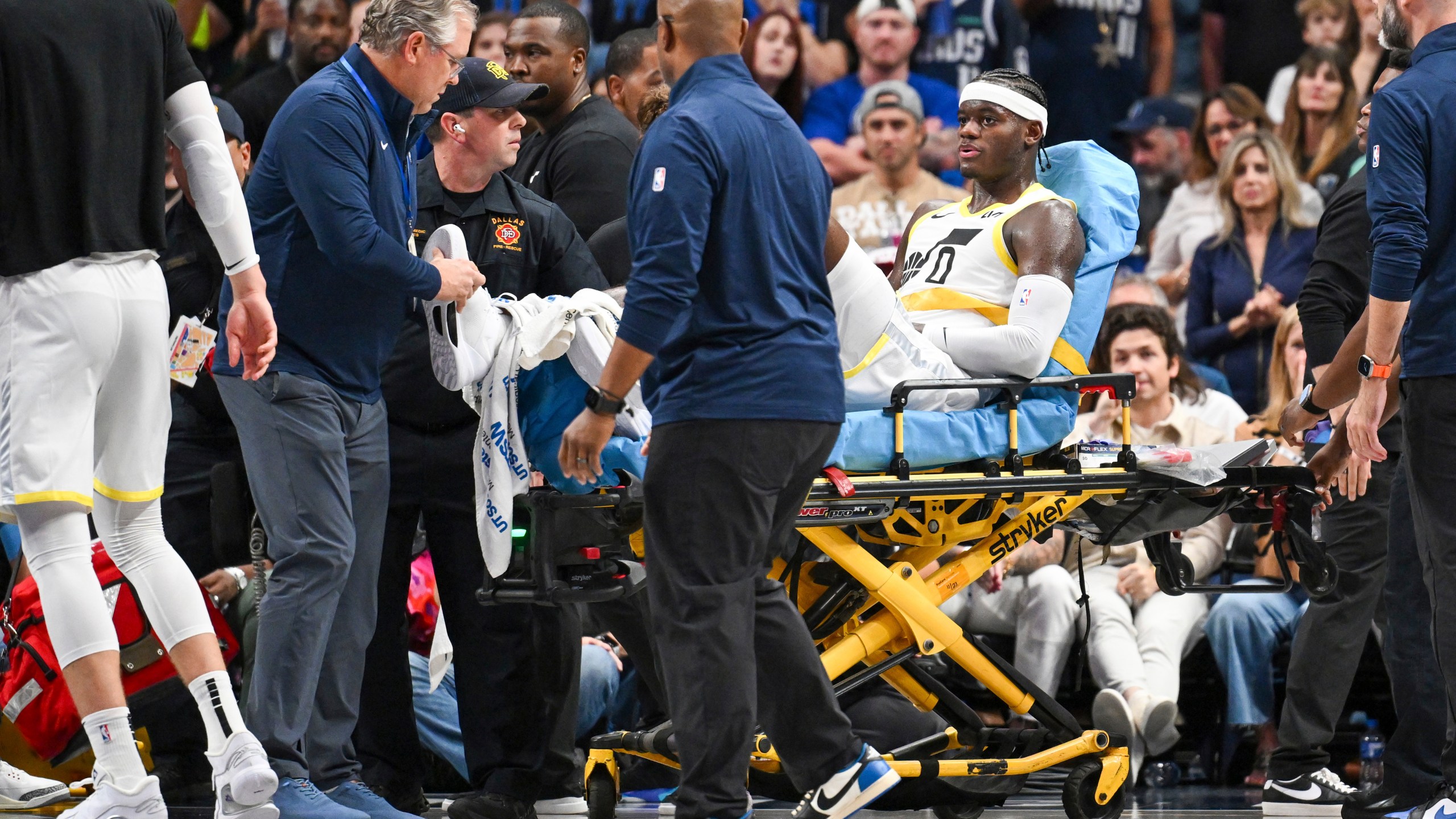 Utah Jazz forward Taylor Hendricks (0) is wheeled off by paramedics after sustaining an injury in the second half during an NBA basketball game against the Dallas Mavericks, Monday, Oct. 28, 2024, in Dallas. (AP Photo/Albert Pena)