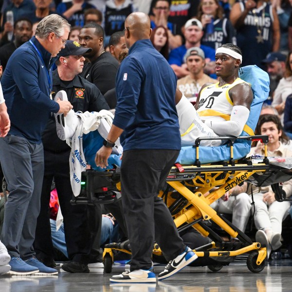 Utah Jazz forward Taylor Hendricks (0) is wheeled off by paramedics after sustaining an injury in the second half during an NBA basketball game against the Dallas Mavericks, Monday, Oct. 28, 2024, in Dallas. (AP Photo/Albert Pena)