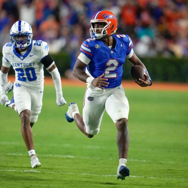 Florida quarterback DJ Lagway (2) runs past Kentucky defensive back Terhyon Nichols (20) during the first half of an NCAA college football game, Saturday, Oct. 19, 2024, in Gainesville, Fla. (AP Photo/John Raoux)