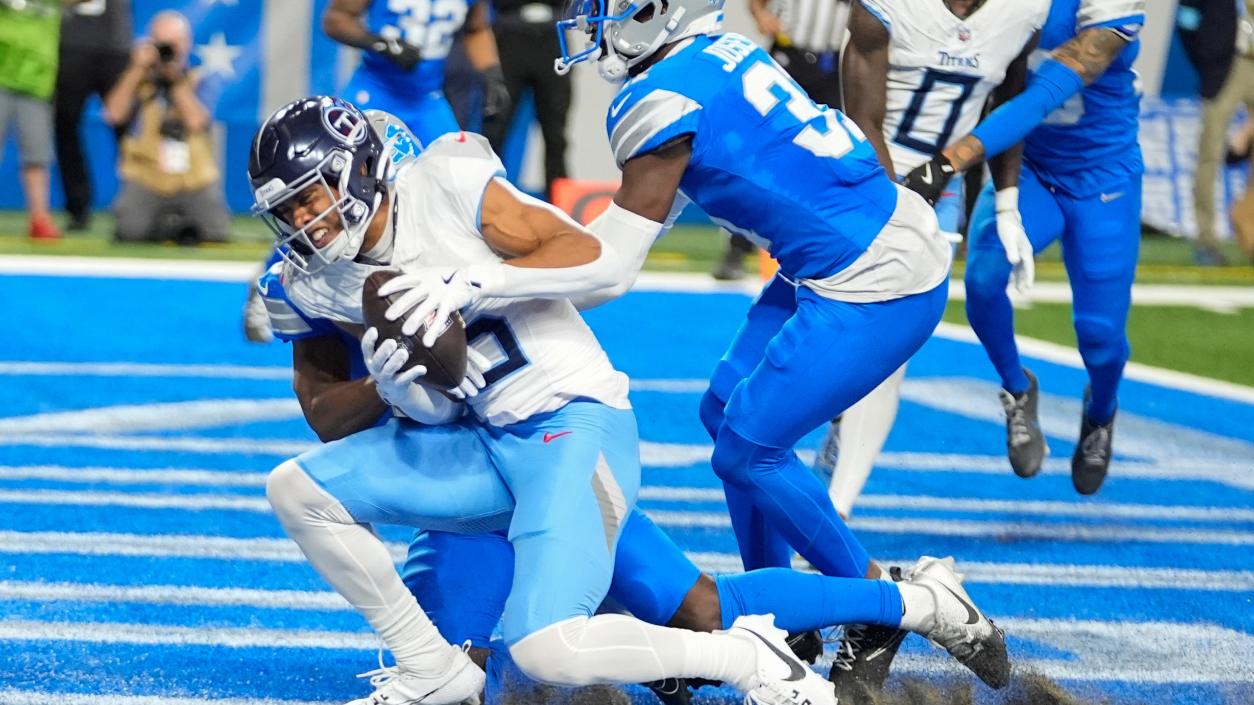 Tennessee Titans wide receiver Nick Westbrook-Ikhine, left, catches a pass in the end zone for a touchdown against the Detroit Lions safety Kerby Joseph, right, during the first half of an NFL football game Sunday, Oct. 27, 2024, in Detroit. (AP Photo/Paul Sancya)