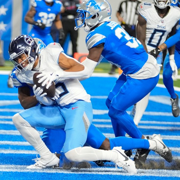 Tennessee Titans wide receiver Nick Westbrook-Ikhine, left, catches a pass in the end zone for a touchdown against the Detroit Lions safety Kerby Joseph, right, during the first half of an NFL football game Sunday, Oct. 27, 2024, in Detroit. (AP Photo/Paul Sancya)