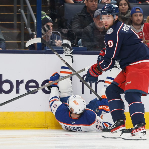 Columbus Blue Jackets' Ivan Provorov, right, knocks Edmonton Oilers' Connor McDavid to the ice during the first period of an NHL hockey game Monday, Oct. 28, 2024, in Columbus, Ohio. (AP Photo/Jay LaPrete)