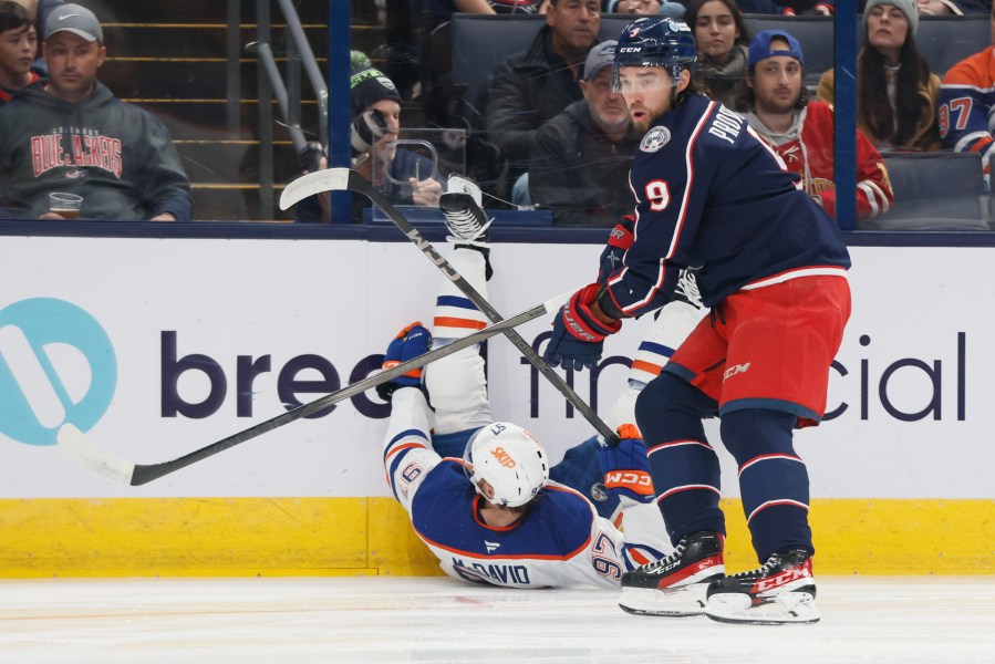 Columbus Blue Jackets' Ivan Provorov, right, knocks Edmonton Oilers' Connor McDavid to the ice during the first period of an NHL hockey game Monday, Oct. 28, 2024, in Columbus, Ohio. (AP Photo/Jay LaPrete)