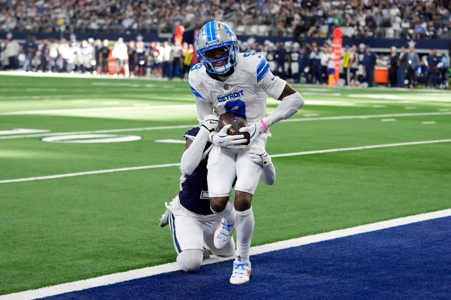 Detroit Lions wide receiver Jameson Williams (9) catches a touchdown pass as Dallas Cowboys cornerback Trevon Diggs, rear, defends in the second half of an NFL football game in Arlington, Texas, Sunday, Oct. 13, 2024. (AP Photo/LM Otero)