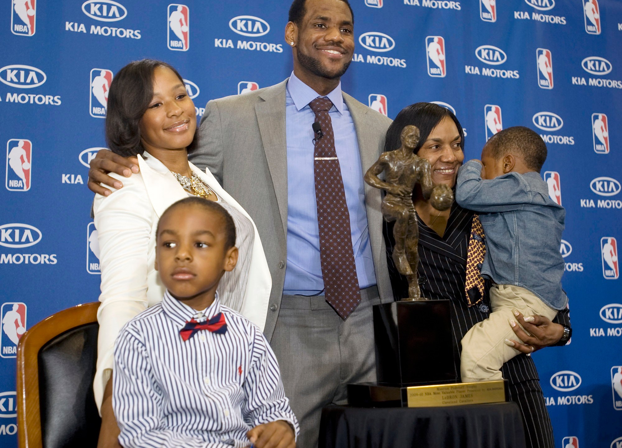 FILE - Cleveland Cavaliers forward and NBA Most Valuable Player LeBron James, center, stands with his family, girfriend, Savannah Brinson, left, in white, son, LeBron Jr., foreground left, James mother Gloria, right, holding James son Bryce, after the NBA MVP award ceremony for James on the University of Akron campus in Akron, Ohio, Sunday, May 2, 2010. (AP Photo/Phil Long, File)