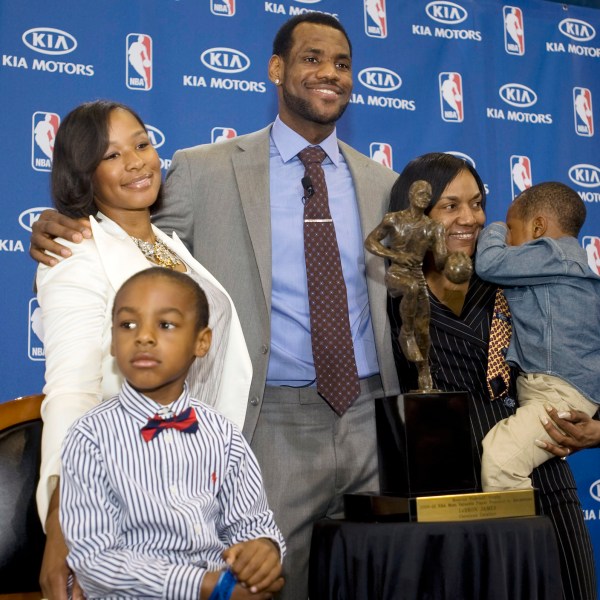 FILE - Cleveland Cavaliers forward and NBA Most Valuable Player LeBron James, center, stands with his family, girfriend, Savannah Brinson, left, in white, son, LeBron Jr., foreground left, James mother Gloria, right, holding James son Bryce, after the NBA MVP award ceremony for James on the University of Akron campus in Akron, Ohio, Sunday, May 2, 2010. (AP Photo/Phil Long, File)