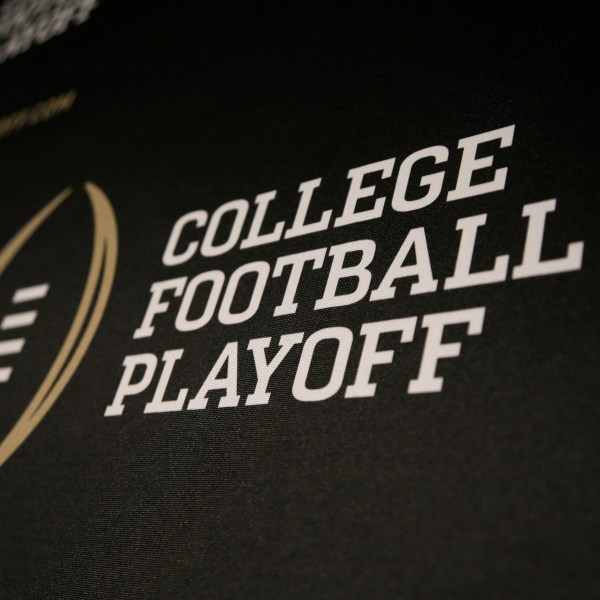 FILE - The College Football Playoff logo is printed across a backdrop during a news conference where the 13 members of the committee were announced, Oct. 16, 2013, in Irving, Texas. (AP Photo/Tony Gutierrez, File)