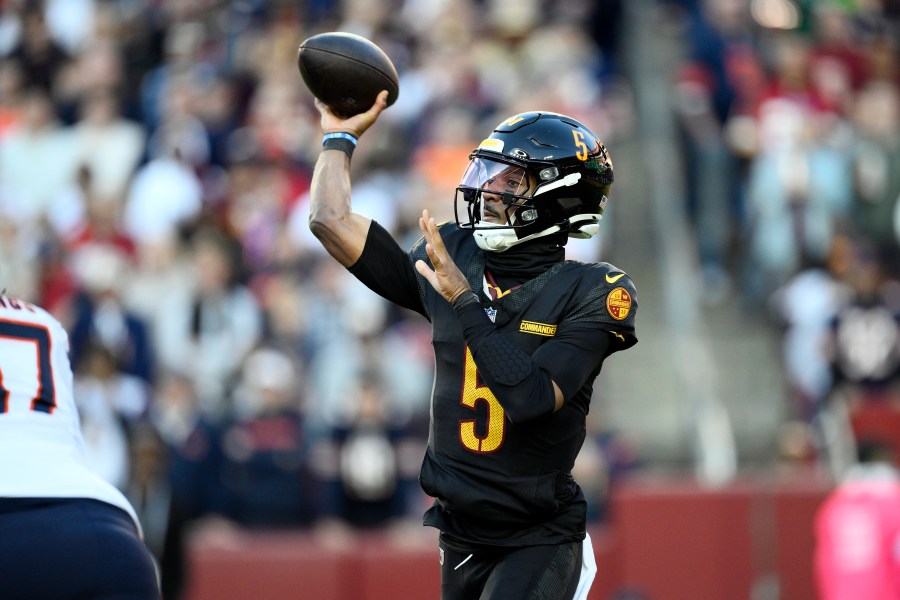 Washington Commanders quarterback Jayden Daniels (5) passes against the Chicago Bears in the first half of an NFL football game Sunday, Oct. 27, 2024, in Landover, Md. (AP Photo/Nick Wass)