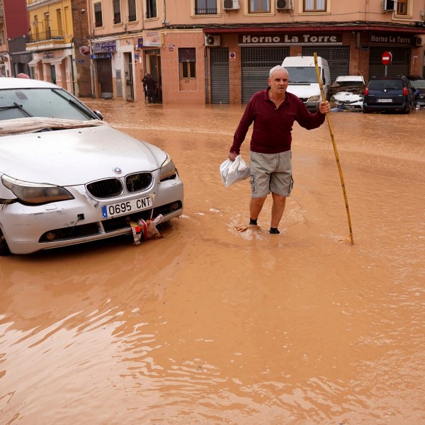 A man walks through flooded streets in Valencia, Spain, Wednesday, Oct. 30, 2024. (AP Photo/Alberto Saiz)