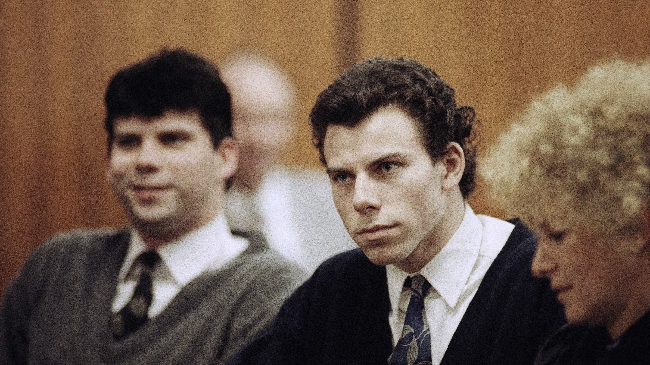 FILE - Lyle, left, and Erik Menendez sit with defense attorney Leslie Abramson, right, in Beverly Hills Municipal Court during a hearing, Nov. 26, 1990. (AP Photo/Nick Ut, File)