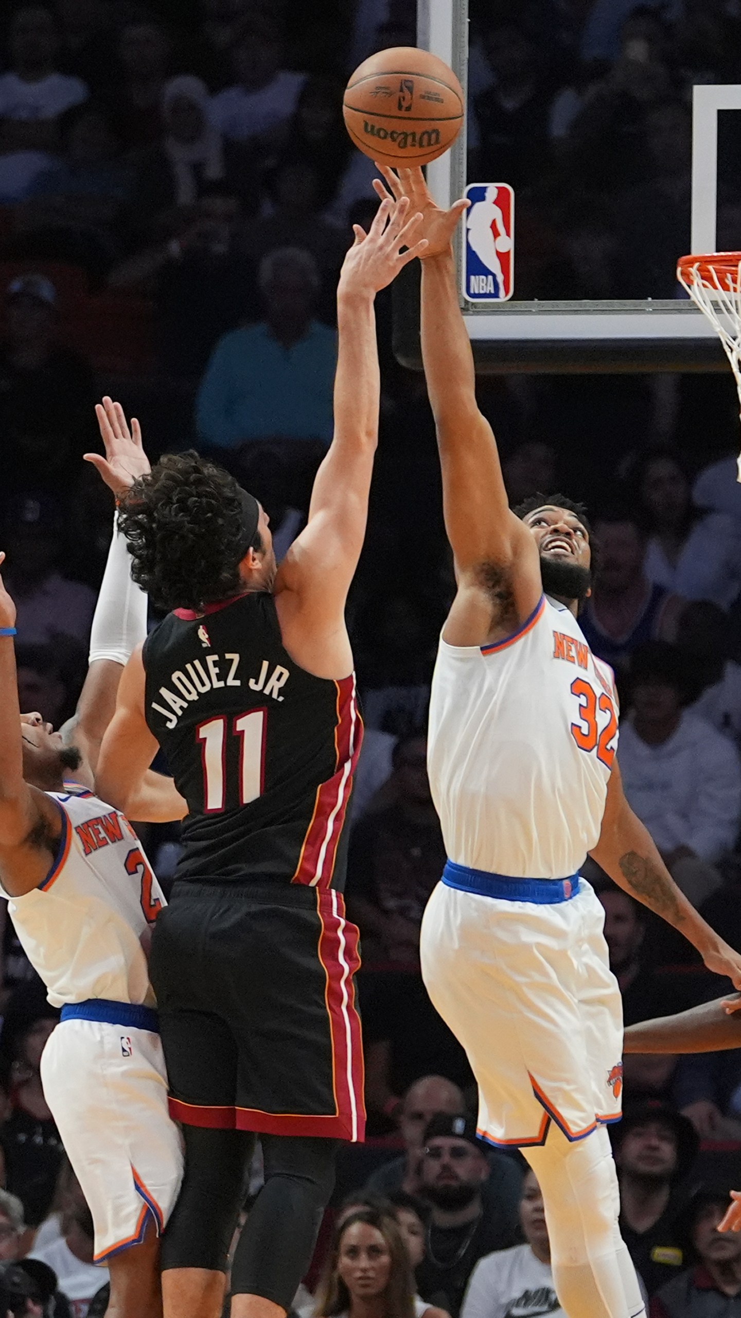 Miami Heat guard Jaime Jaquez Jr. (11) shoots as New York Knicks center Karl-Anthony Towns (32) defends during the first half of an NBA basketball game, Wednesday, Oct. 30, 2024, in Miami. (AP Photo/Lynne Sladky)