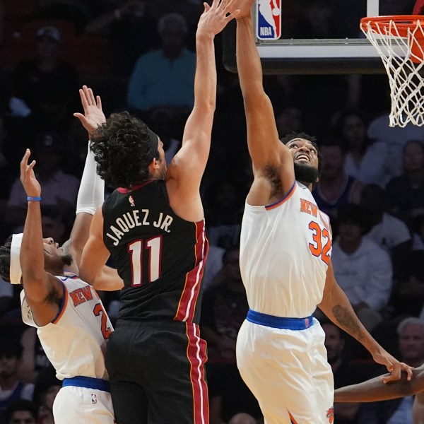 Miami Heat guard Jaime Jaquez Jr. (11) shoots as New York Knicks center Karl-Anthony Towns (32) defends during the first half of an NBA basketball game, Wednesday, Oct. 30, 2024, in Miami. (AP Photo/Lynne Sladky)