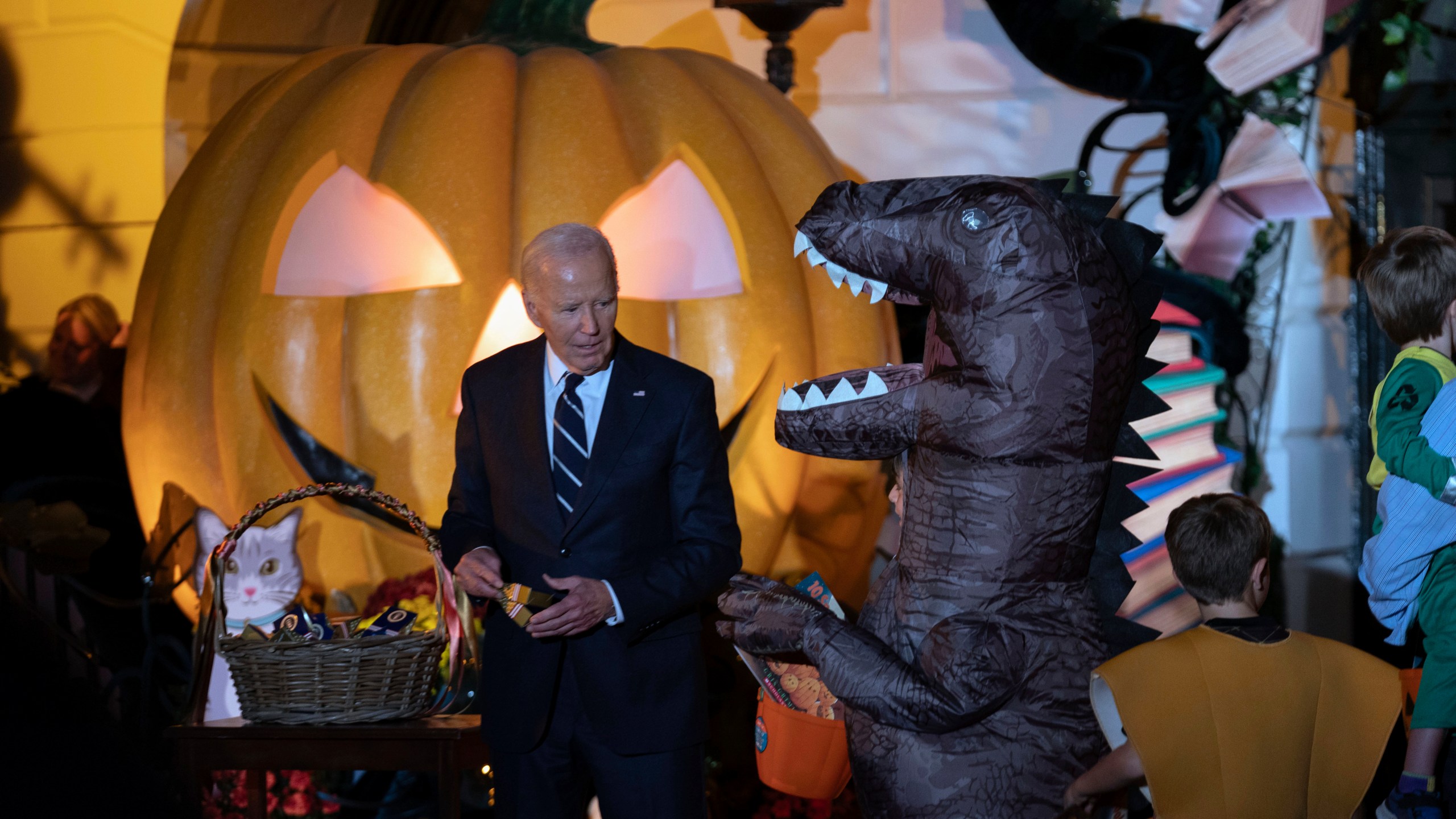 President Joe Biden gives treats to trick-or-treaters at the South Lawn of the White House on Halloween in Washington, Wednesday, Oct. 30, 2024. (AP Photo/Jose Luis Magana)