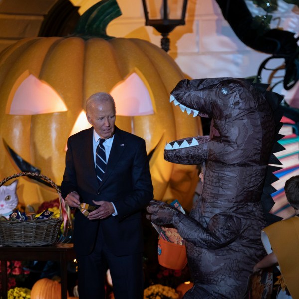 President Joe Biden gives treats to trick-or-treaters at the South Lawn of the White House on Halloween in Washington, Wednesday, Oct. 30, 2024. (AP Photo/Jose Luis Magana)