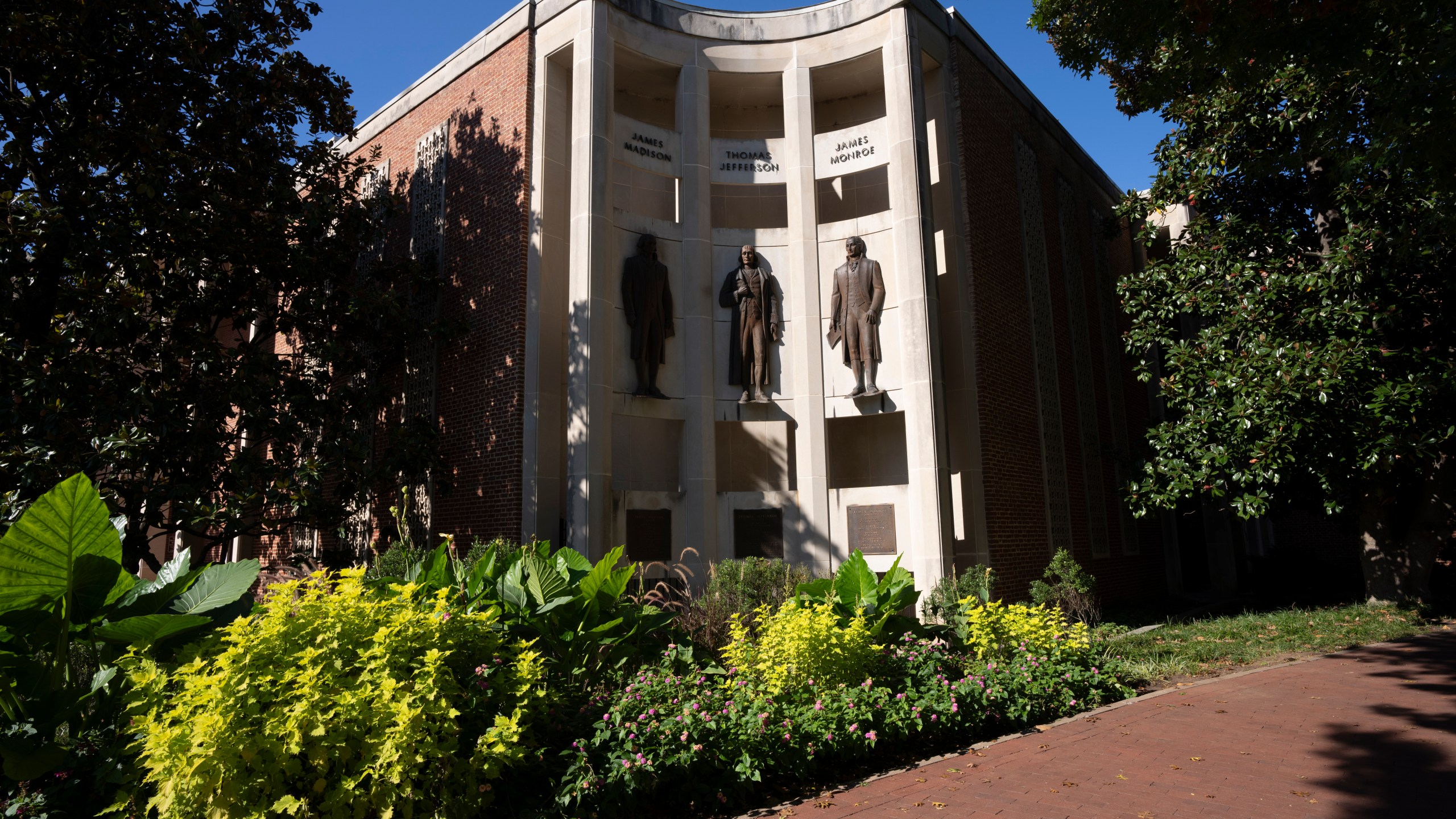 Statues of James Madison, Thomas Jefferson and James Monroe are seen at the city hall Oct. 10, 2024, in Charlottesville, Va. (AP Photo/Serkan Gurbuz)