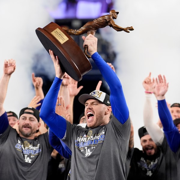 Los Angeles Dodgers' Freddie Freeman celebrates with the MVP trophy after their win against the New York Yankees in Game 5 to win the baseball World Series, Thursday, Oct. 31, 2024, in New York. (AP Photo/Ashley Landis)