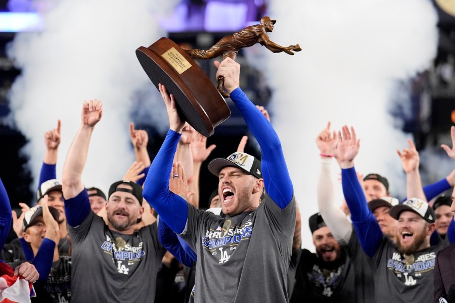 Los Angeles Dodgers' Freddie Freeman celebrates with the MVP trophy after their win against the New York Yankees in Game 5 to win the baseball World Series, Thursday, Oct. 31, 2024, in New York. (AP Photo/Ashley Landis)