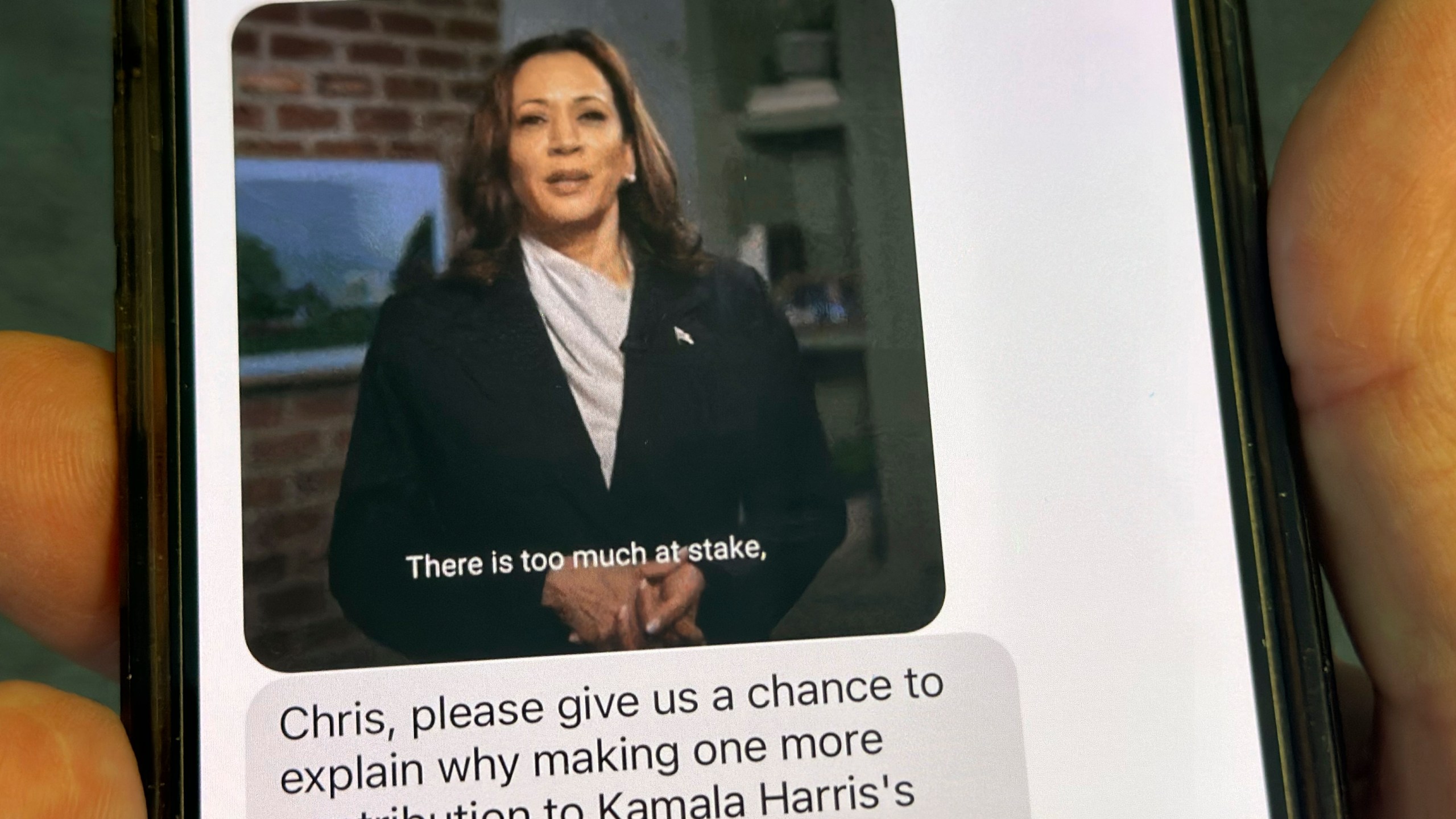 A text is viewed on a mobile device Wednesday, Oct. 30, 2024, in Washington, as across the U.S., people's phones are pinging with text messages from Donald Trump, Kamala Harris and their allies in the presidential campaign's final days. (AP Photo/Jon Elswick)