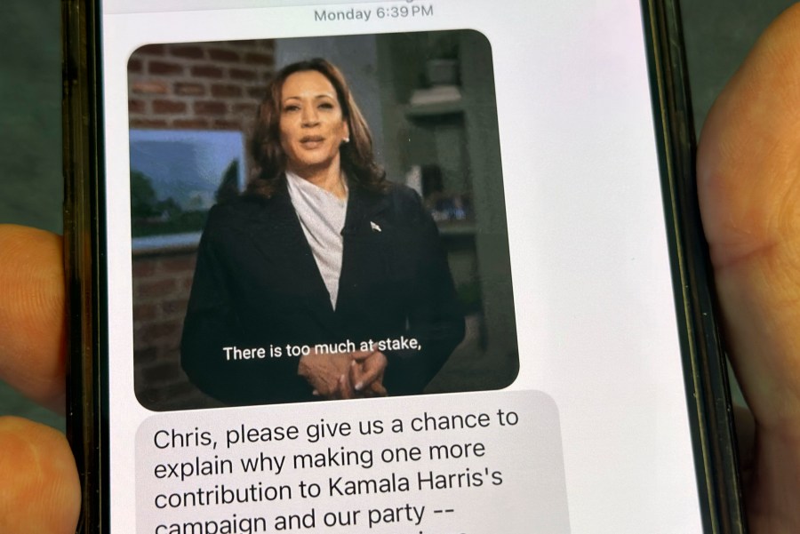 A text is viewed on a mobile device Wednesday, Oct. 30, 2024, in Washington, as across the U.S., people's phones are pinging with text messages from Donald Trump, Kamala Harris and their allies in the presidential campaign's final days. (AP Photo/Jon Elswick)