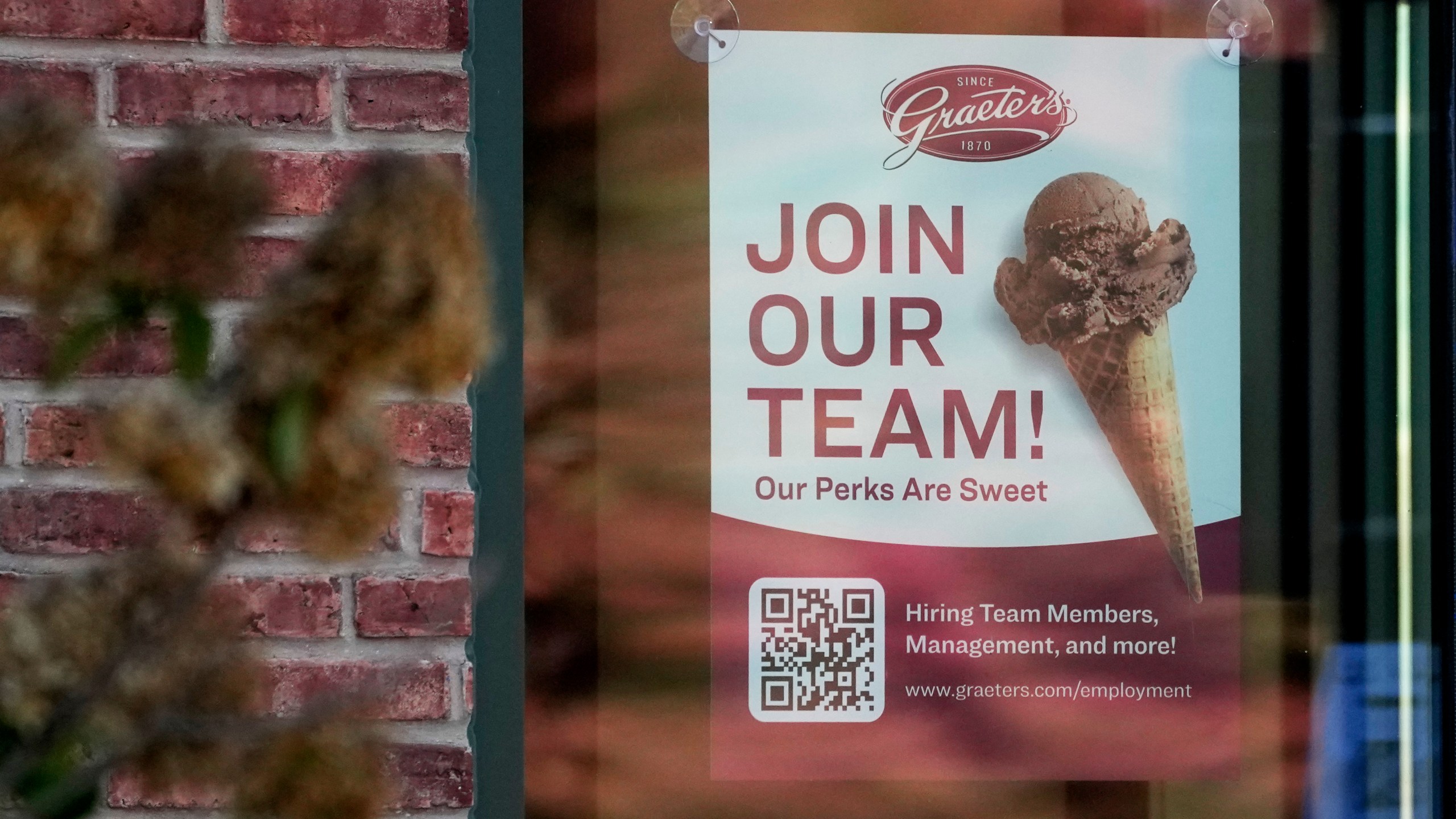 A sign soliciting job applicants is displayed at an ice cream shop in Northbrook, Ill., Sunday, Oct. 27, 2024. (AP Photo/Nam Y. Huh)