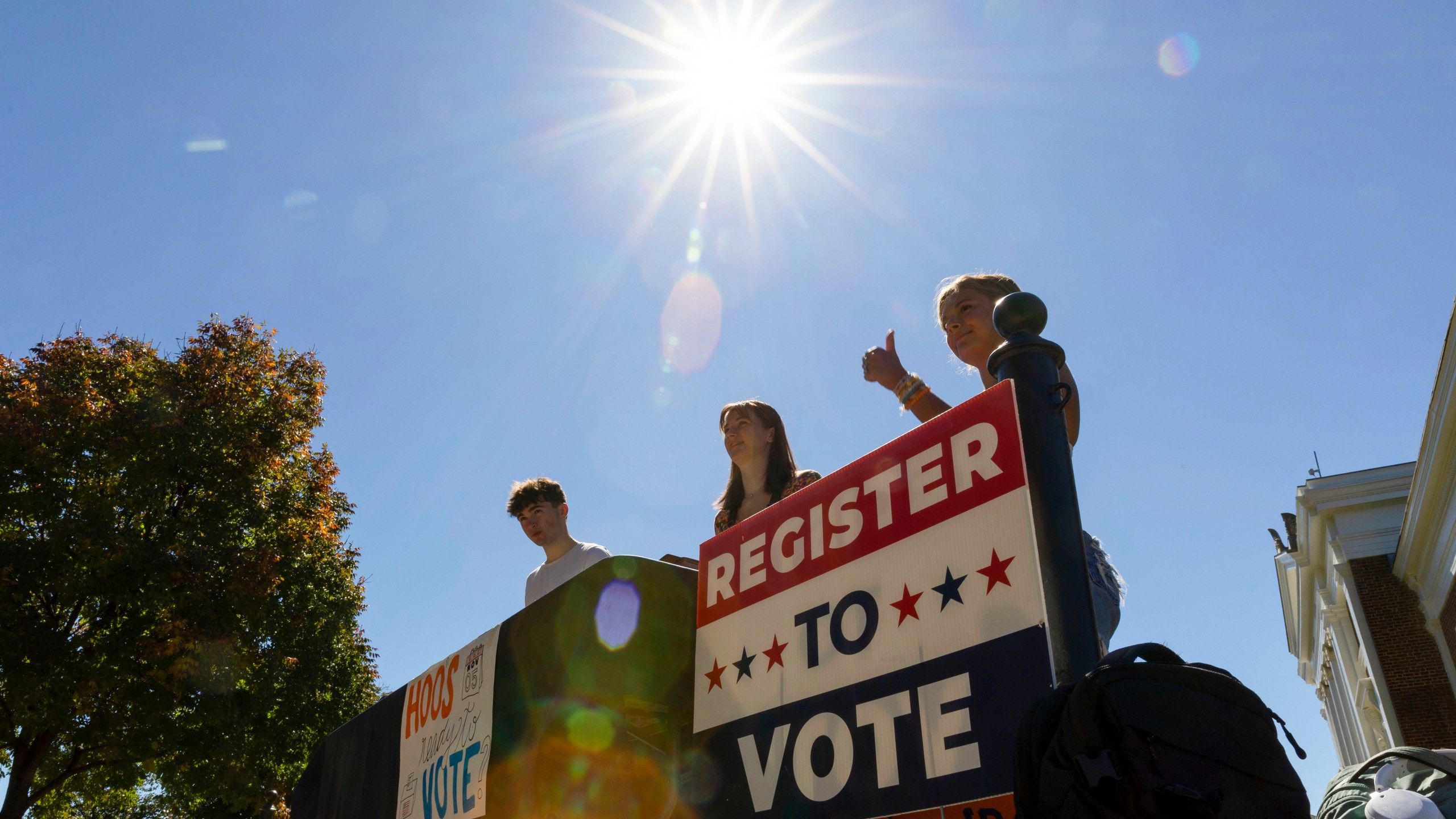 James Galvin, Ella Nelsen and Charlotte Papacosma register students to vote at the University of Virginia in Charlottesville, Va., Friday, Oct. 11, 2024. (AP Photo/Ryan M. Kelly)