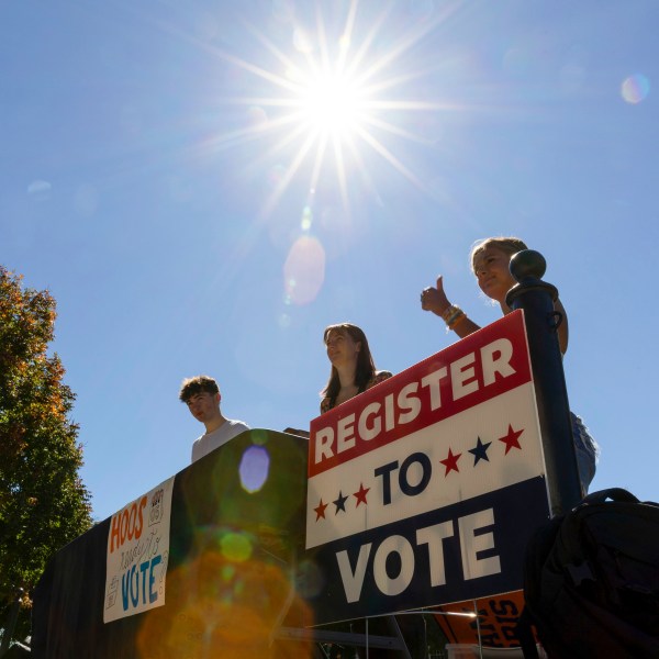 James Galvin, Ella Nelsen and Charlotte Papacosma register students to vote at the University of Virginia in Charlottesville, Va., Friday, Oct. 11, 2024. (AP Photo/Ryan M. Kelly)