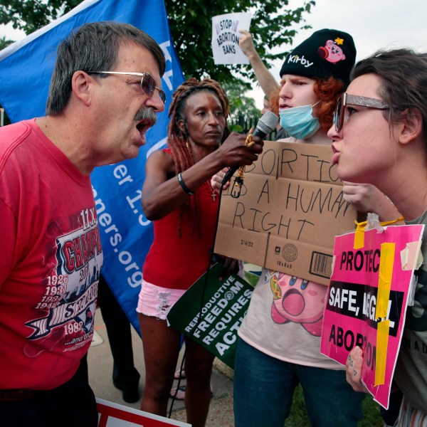 FILE - Steve Sallwasser, of Arnold, debates Brittany Nickens, of Maplewood, during competing rallies outside Planned Parenthood of Missouri, following the U.S. Supreme Court decision to overturn Roe v. Wade, June 24, 2022, in St. Louis. (Robert Cohen/St. Louis Post-Dispatch via AP, File)