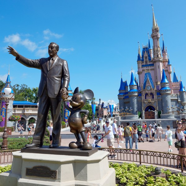 FILE - Guests pass a statue of Walt Disney and Mickey Mouse in the Magic Kingdom at Walt Disney World on July 14, 2023, in Lake Buena Vista, Fla. (AP Photo/John Raoux, File)